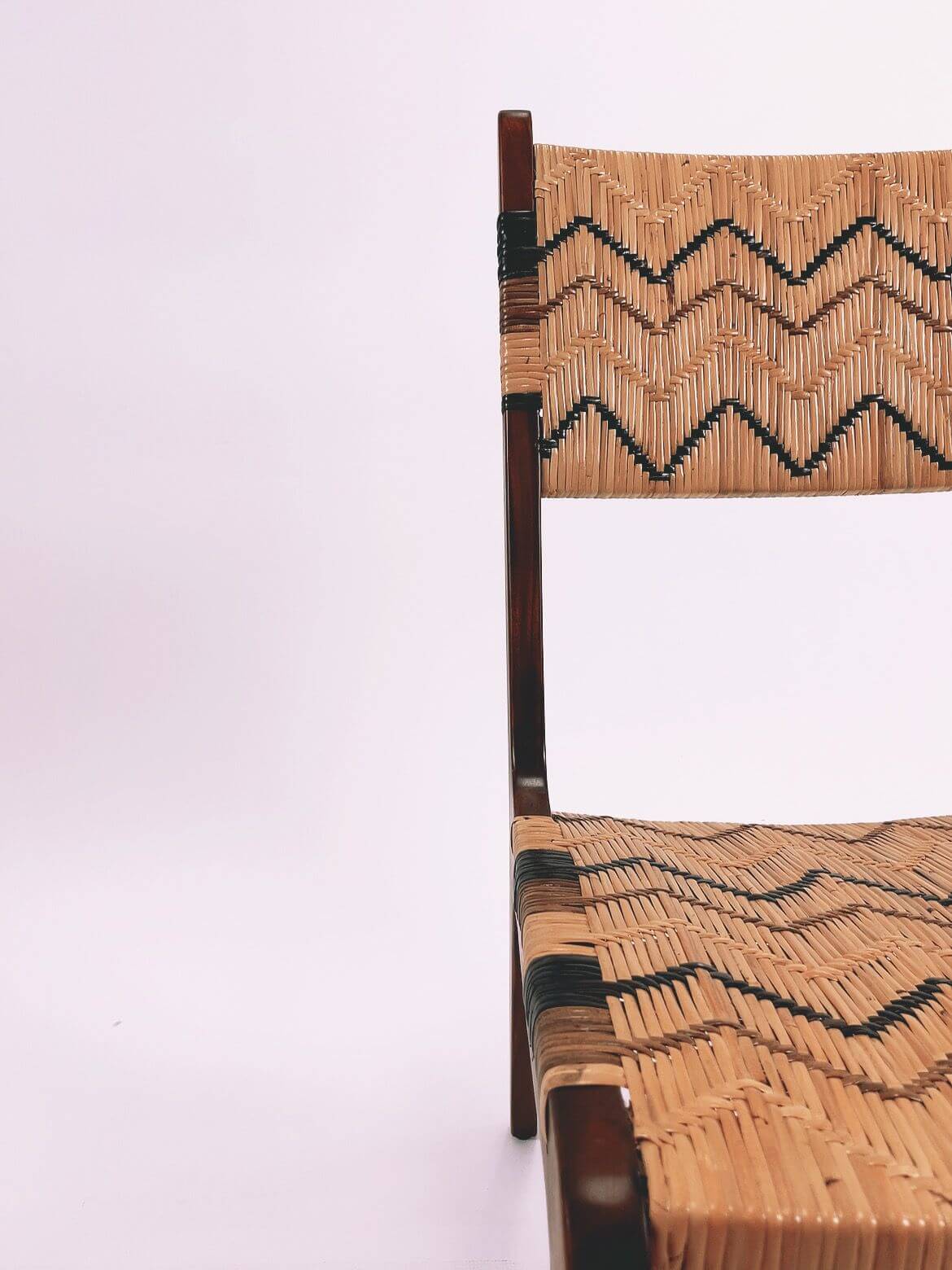 A partially visible Designer Dining Chair (Clearance) featuring a zigzag pattern on the seat and backrest, set against a plain white background.