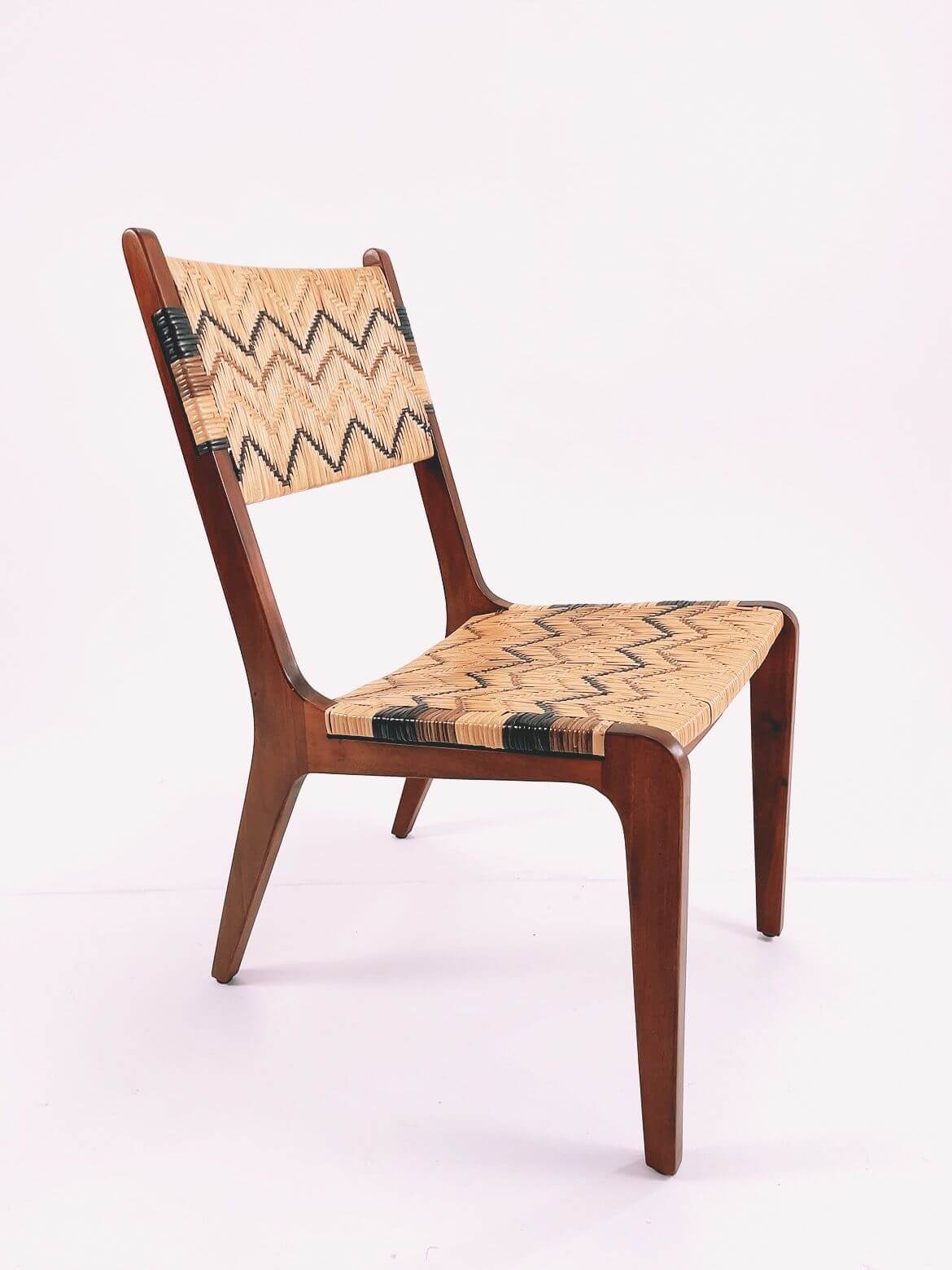 A wooden Designer Dining Chair (Clearance) with a woven seat and backrest featuring zigzag patterns, set against a plain white background.