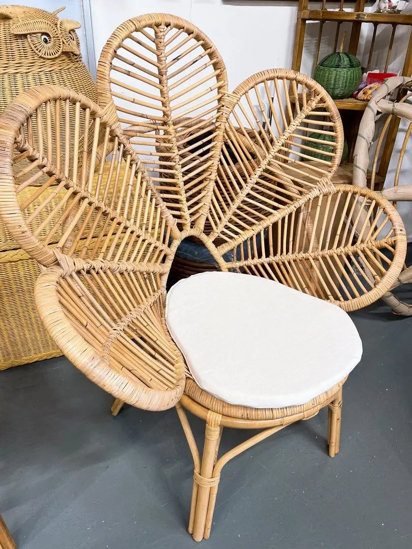 A Natural White Rattan Leaf Chair featuring a floral petal-shaped backrest and a white cushion seat displayed indoors.