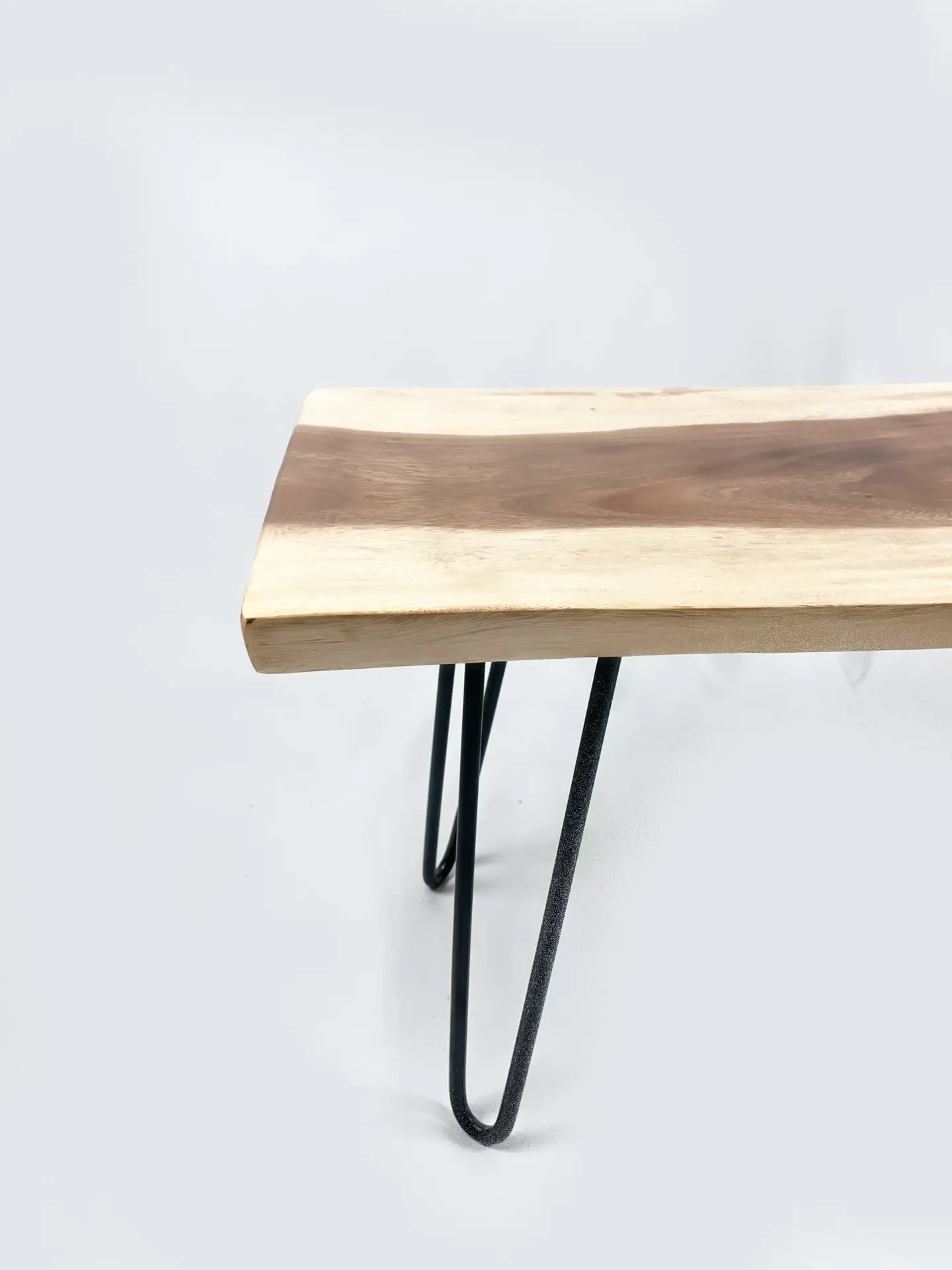 The Teak Art Bench 2 features wooden seating with a natural wood grain finish, supported by metal hairpin legs, all displayed against a plain white background.