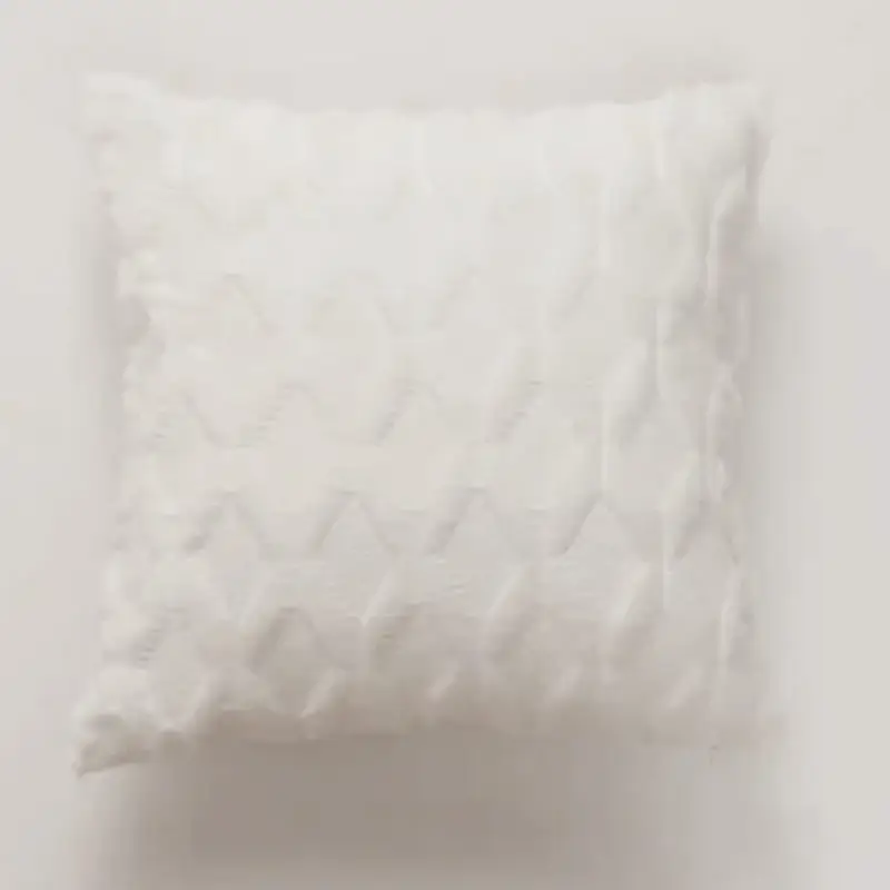 The Abstract Textured Embroidery Cushion Cover is a white square throw pillow featuring a subtle chevron pattern on a plain background.