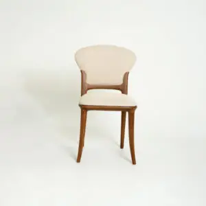 A wood-framed chair with four legs, featuring a curved beige upholstered backrest and seat, positioned against a plain white background.