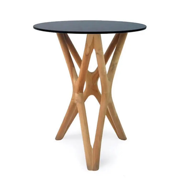 The Trio Side Table features a round, black tabletop and a wooden base with an intricate design.