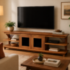 A living room featuring a wall-mounted flat-screen TV above the Bravo TV Console (Clearance), which holds books and decor, with a potted plant, framed art, and a large leafy plant in a woven basket. A living room featuring a wall-mounted flat-screen TV above the Bravo TV Console (Clearance), which holds books and decor, with a potted plant, framed art, and a large leafy plant in a woven basket.