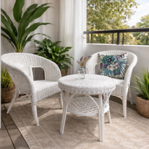 A small patio features two White Wicker Chairs, a matching round table, potted plants, a patterned rug, string lights above, and sheer curtains partially drawn.