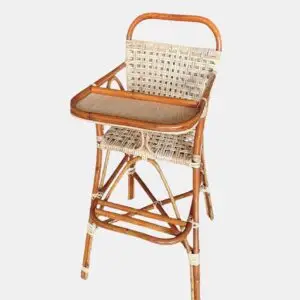 The RC Baby Meal Chair is made of woven wicker with a wooden frame and features armrests, a footrest, and a tray.
