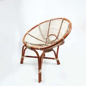 The RC Brown Coil Hami Chair 27" features a round, rattan seat with a distinctive bowl shape and is supported by a sturdy wooden frame with four legs. It boasts a natural rattan finish and is elegantly set against a plain white background.