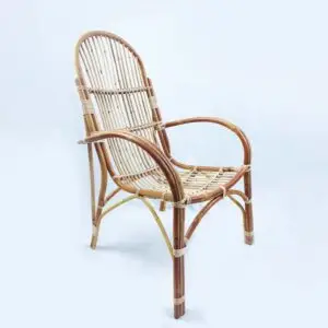 The RC New Patio Chair, made of natural rattan and featuring a curved backrest and armrests with a woven seat design, is showcased against a plain white background.