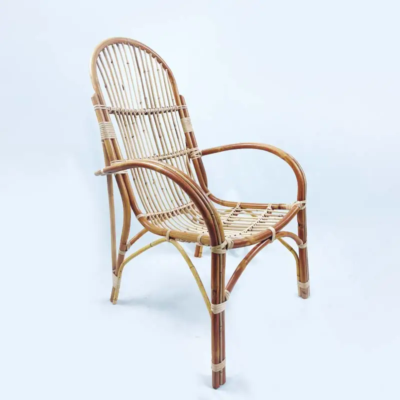 The RC New Patio Chair, made of natural rattan and featuring a curved backrest and armrests with a woven seat design, is showcased against a plain white background.