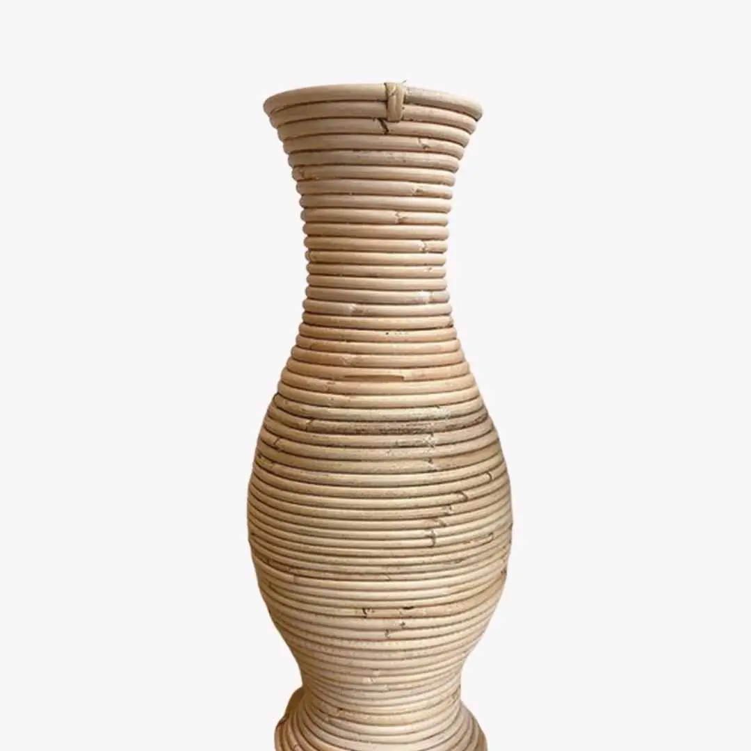 A tall Rattan Vase with a vase-shaped form, featuring a narrow neck and a wider, rounded base, elegantly displayed against a plain white background.
