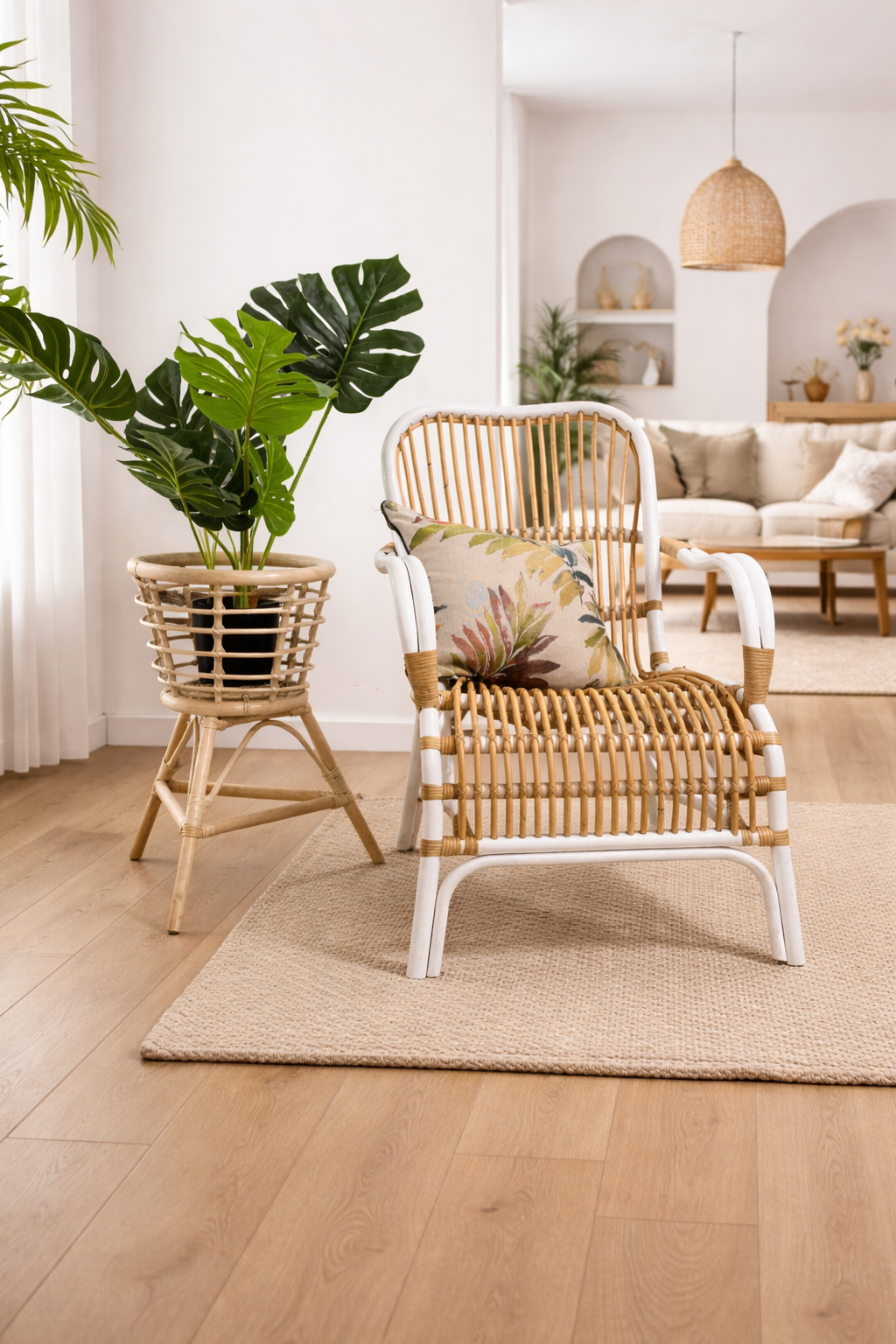 A Classic White Chair sits next to a potted plant on a woven mat in a bright, modern living room with wooden flooring.