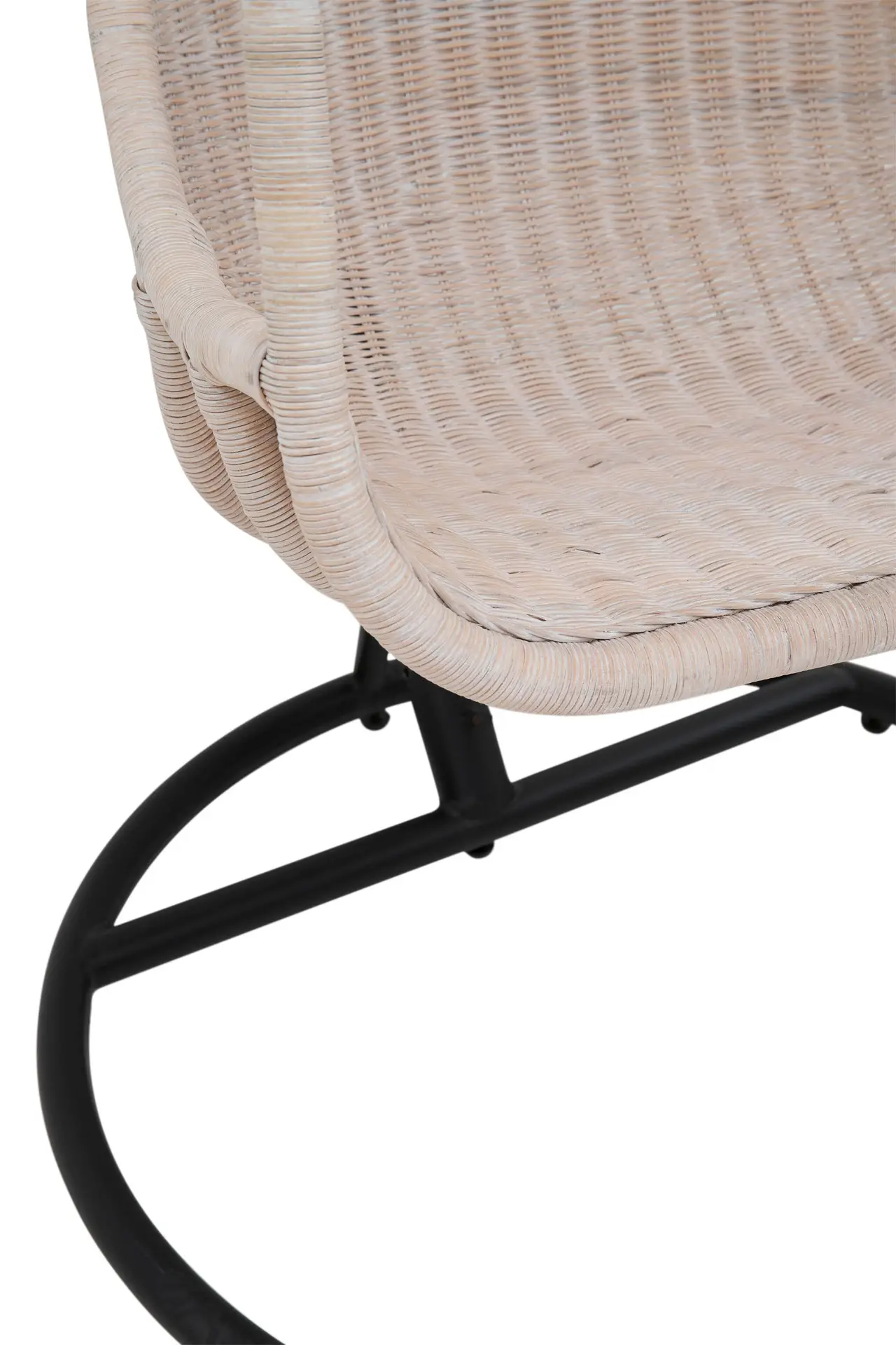 Close-up of a product named "Rattan White Wicker Swing With Seat Cushion," featuring beige wicker and a black metal base.