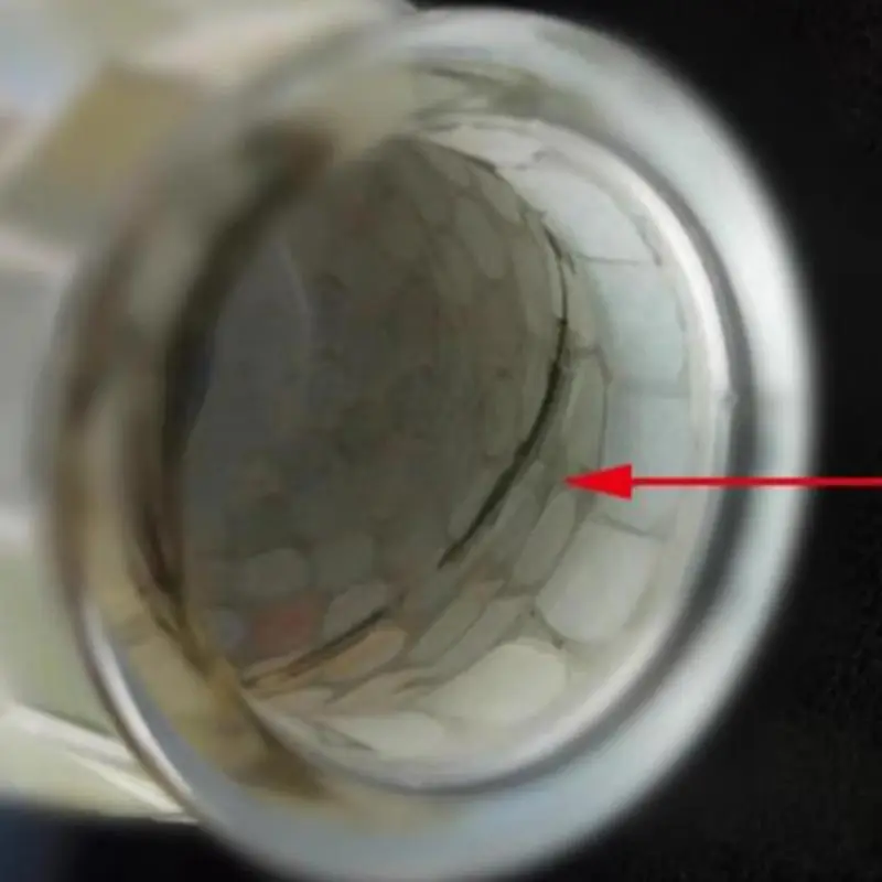 Close-up image of the Creative Mosaic Glass Vase's interior surface with a red arrow pointing to a crack running along the inner wall.